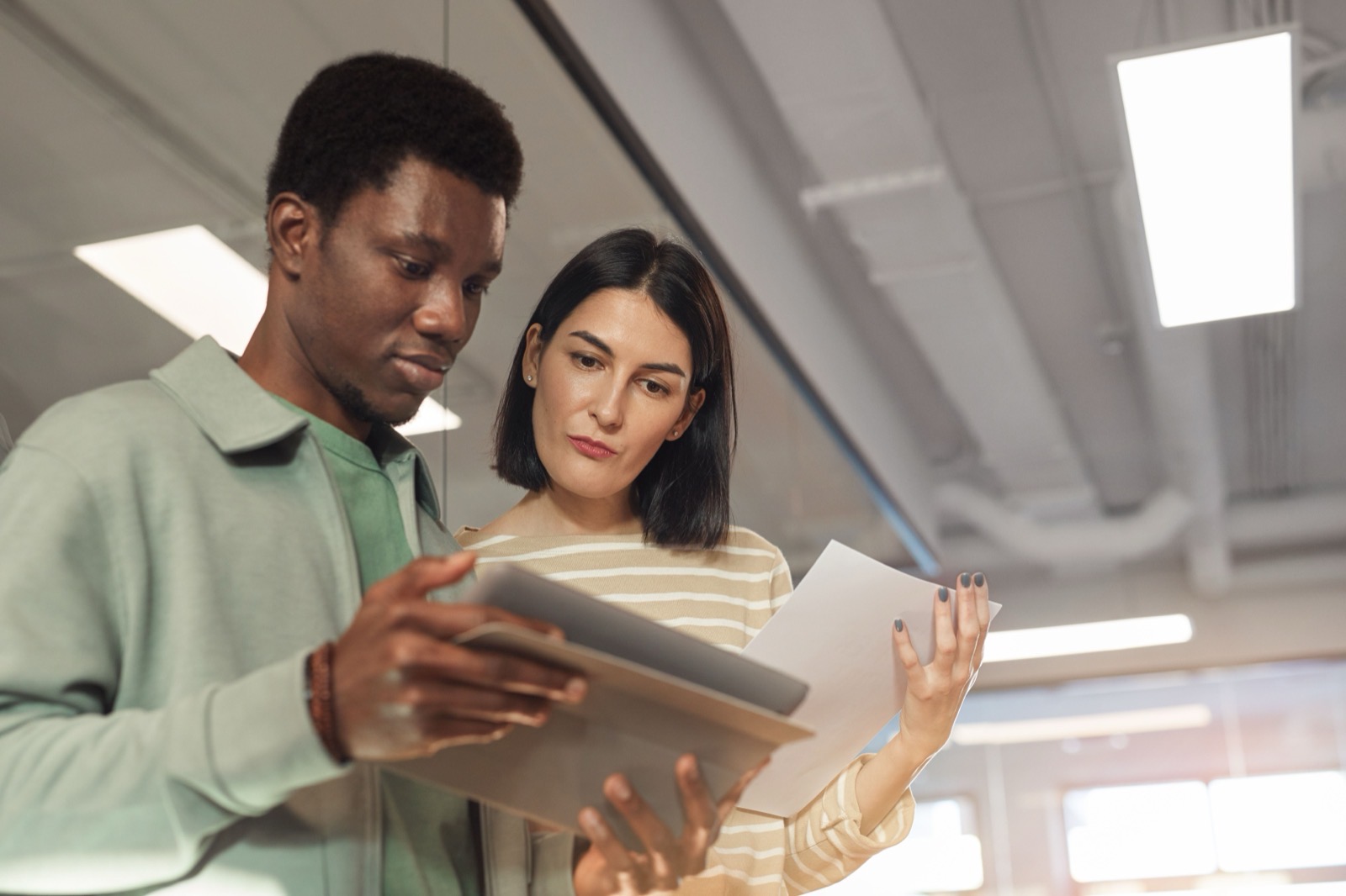 A professional services team reviewing client records together in a small office